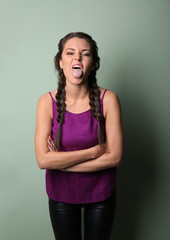 Portrait of naughty young woman on color background