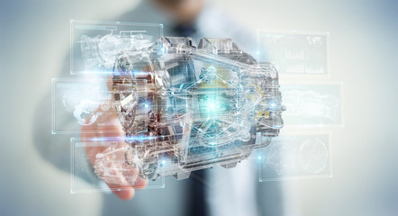 Businessman using wireframe holographic 3D digital projection of an engine