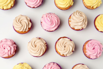 Delicious cupcakes on white background, flat lay - Powered by Adobe