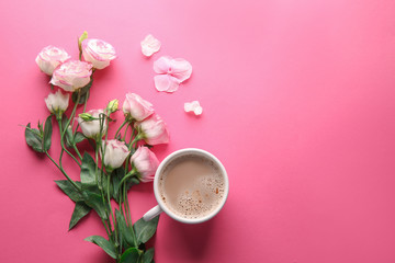 Beautiful flowers and cup of coffee on pink background