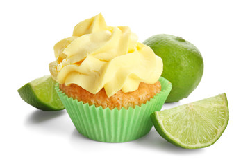 Delicious cupcake and lime on white background
