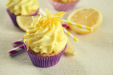 Delicious lemon cupcake on table