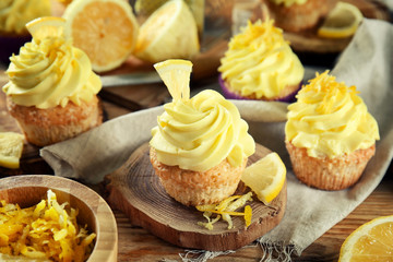 Delicious lemon cupcakes on wooden table