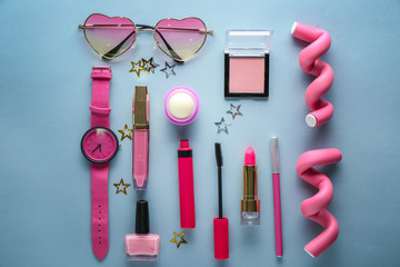 Set of decorative cosmetics with accessories on color background
