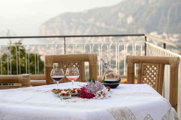 Table on the terrace prepared for a romantic dinner overlooking the Gulf of Naples and Mount...