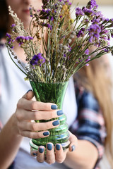Woman with stylish beautiful manicure holding vase, closeup