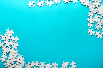 Pieces of jigsaw puzzle on color background