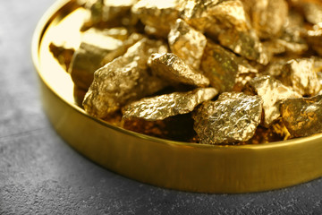 Gold nuggets on plate, closeup
