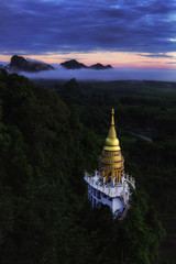 Beautiful pagoda at sunrise on the top  with fog at Khao Na Nai Luang Dharma Park,Surat Thani province,Thailand.
