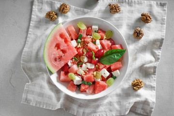 Plate with delicious watermelon salad on table