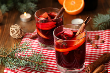 Glasses of delicious mulled wine on wooden table