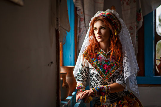 Beautiful Girl In A Hut In National Slavic Costume