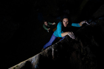Two girls practice bouldering in the evening