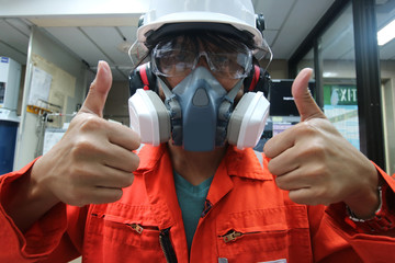 Multi-purpose respirator half mask for toxic gas protection.The man prepare to wear Multi-purpose...