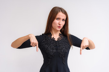 Studio portrait of a beautiful brunette girl on a white background with different emotions.