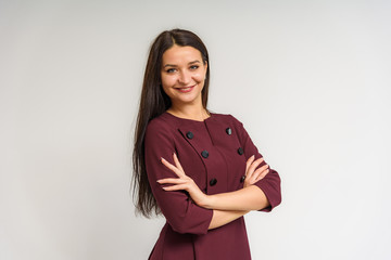 Fototapeta premium Studio portrait of a beautiful brunette girl on a white background with different emotions.