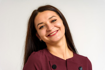 Fototapeta premium Studio portrait of a beautiful brunette girl on a white background with different emotions.