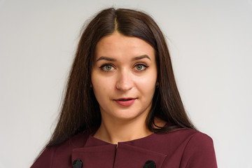 Studio portrait of a beautiful brunette girl on a white background with different emotions.