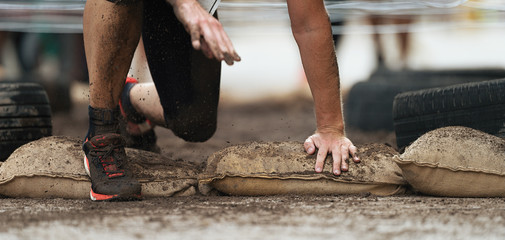 Crawling passing under a barbed wire obstacles, obstacle course in the city