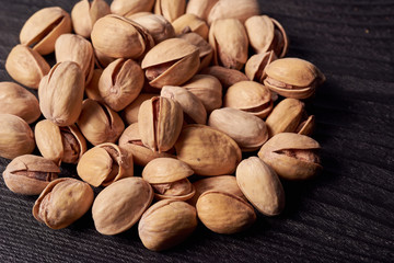 Pistachios in the shape of heart on a blue background