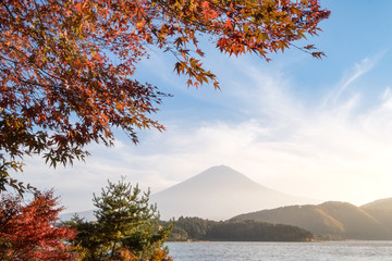 Mount Fuji at Kawaguchiko lake in afternoon sunshine rise with autumn colorful maple leaf.