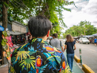 Handsome Asian male walking in Chatuchak Weekend Market Bangkok Thailand