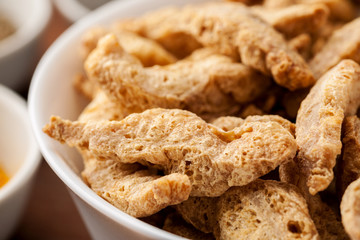 Raw dry soya meat chunks in a white bowl, macro shot