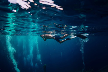 Man free diver swimming in ocean, underwater photo with diver