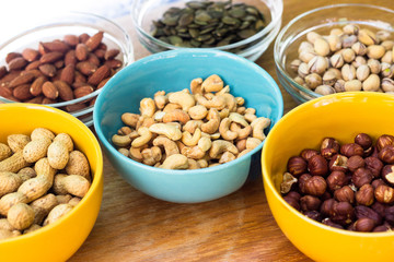 Assortment of mixed nuts on wood table background 