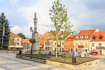 Fototapeta na wymiar Fragment of Old Market Square with Tenement Houses and Our Lady statue in Sandomierz, Poland