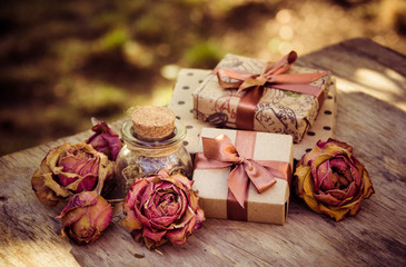 Gift boxes and dry roses. Dried flowers and craft gift box. Romantic concept. Gifts in brown paper