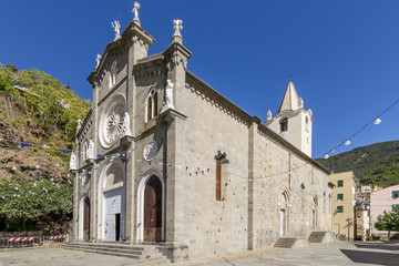 Fototapeta na wymiar The beautiful Church of St. John the Baptist against the blue sky, Riomaggiore, Cinque Terre, Liguria, Italy