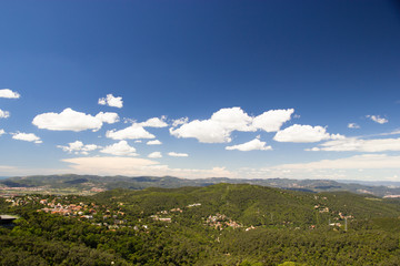 View on mountains and green forest from Tibidabo hill in Barcelona, Spain