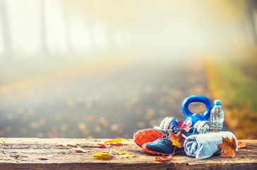 Blue sport shoes and water laid on a wooden board.