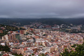 Cloudy view on Barcelona city from the mountain