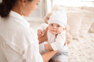 Mother, playing with her toddler boy smiling