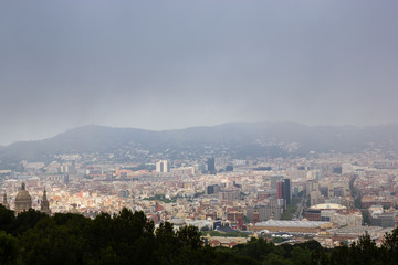 Fototapeta na wymiar View on the Barcelona cloudy city from the Montjuic hill