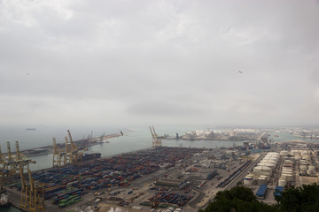 View on cloudy Barcelona industrial port from the Montjuic hill. Photo made on 12 May 2017 in Barcelona, Spain.