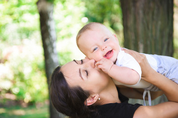 Happy mother and daughter laughing together outdoors