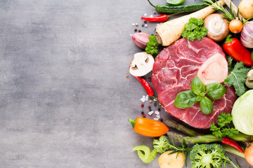 Raw fresh meat Ribeye Steak with vegetables and spice.
