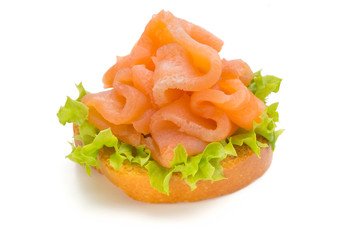 Bread with fresh salmon fillet isolated on white background, top view.