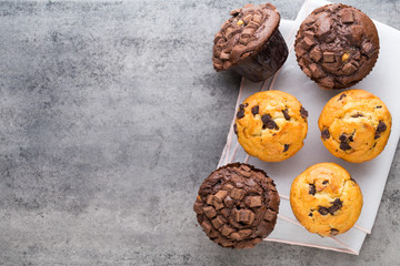 Homemade chocolate muffins on the vintage background.