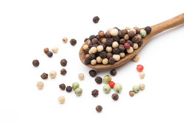 Pepper mix seed on spoon on white background.