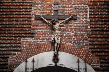 Statue of Jesus Christ on a brick wall background/