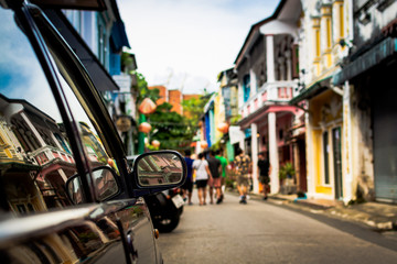 Focus at sideview mirror of a car in phuket old town.