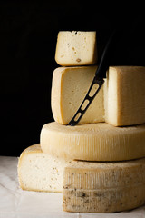 Various types of cheese on a black background.
