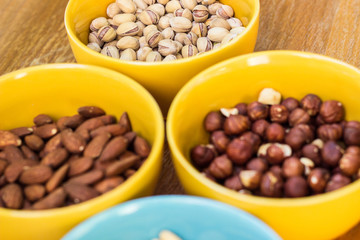 Assortment of mixed nuts on wood table background 