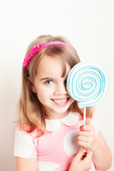Little girl smiling holding lolli pop