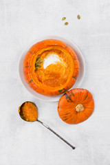 Traditional pumpkin soup in the plate of whole small pumpkin