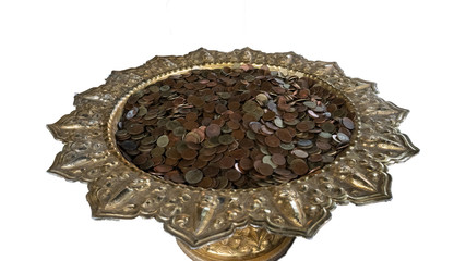 Many coins on a white background tray.